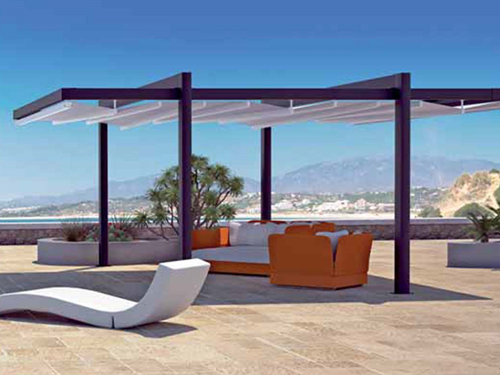 A pergola awning on a deck with couches and chairs